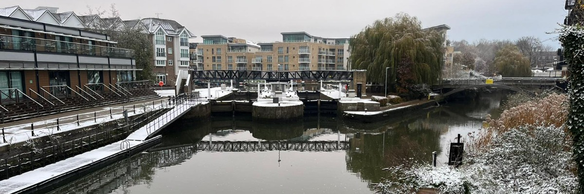 External view of hotel across water with snow